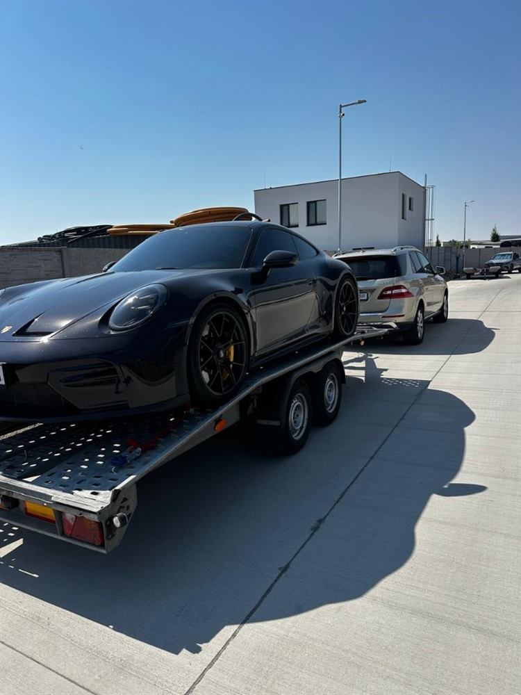 Myroslav transporting a Porsche on a trailer