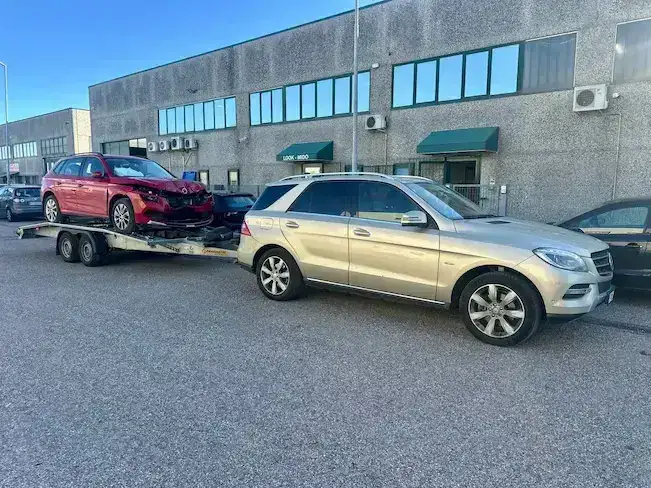 Loading a car onto a tow truck after an accident on the highway